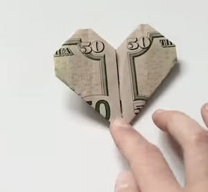 A fifty dollar bill folded into a heart shape, money from MDJ court