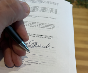 Hand signing agreement to settled disputes through arbitration in PA