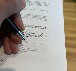 Person signing contract for a loan, or commercial construction
