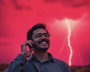 A person talks on a cell phone, with lightning in the background, a metaphor for harming one's case, absent a privilege 